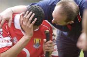 29 June 2003; David Young of Cork is consoled by Bobby Thornhill, Cork team official, after his side's defeat of the Munster Minor Hurling Championship Final match between Cork and Tipperary at Semple Stadium in Thurles, Tipperary. Photo by David Maher/Sportsfile