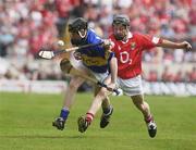 29 June 2003; Richie Ruth of Tipperary in action against Michael Aherne of Cork during the Munster Minor Hurling Championship Final match between Cork and Tipperary at Semple Stadium in Thurles, Tipperary. Photo by David Maher/Sportsfile