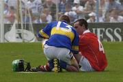 29 June 2003; Mattie Foley of Cork is consoled by Ritchie Ruth of Tipperary after the Munster Minor Hurling Championship Final match between Cork and Tipperary at Semple Stadium in Thurles, Tipperary. Photo by Pat Murphy/Sportsfile