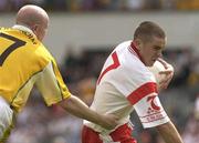 15 June 2003; Philip Jordan, Tyrone, in action against Antrim's Anto Finnegan. Bank of Ireland Ulster Senior Football Championship, Tyrone v Antrim, Casement Park, Belfast. Picture credit; David Maher / SPORTSFILE *EDI*