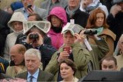 24 April 2013; A general view of racegoers using newspapers to shelter from the rain as they watch the Guinness Handicap Steeplechase race from the stand. Punchestown Racecourse, Punchestown, Co. Kildare. Picture credit: Barry Cregg / SPORTSFILE