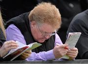 25 April 2013; Ger Markey, from Kilcullen, Co. Kildare, studies the form ahead of the Bibby Financial Services Handicap Steeplechase. Punchestown Racecourse, Punchestown, Co. Kildare. Picture credit: Barry Cregg / SPORTSFILE