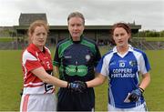 28 April 2013; Cork captain Ann Marie Walsh, left, and Laois captain Maggie Murphy exchange a handshake in the company of referee PJ Rabbitte before the game. TESCO HomeGrown Ladies National Football League, Division 1, Semi-Final, Cork v Laois, Sean Treacy Park, Tipperary Town. Picture credit: Diarmuid Greene / SPORTSFILE