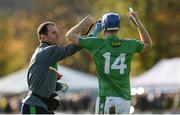 21 October 2017; Ireland physio Tony Spain tends to John McGrath during the Shinty International match between Ireland and Scotland at Bught Park in Inverness, Scotland. Photo by Piaras Ó Mídheach/Sportsfile