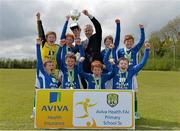 16 May 2013; Alan Kavanagh, Executive Manager, Aviva Health, presents Kian Gilmore, captain, Fermoyle NS, Co. Longford, and his team-mates with the cup after they won Boy's Section A. Aviva Health FAI Primary School 5's, Leinster Finals, MDL Grounds, Trim Road, Navan, Co. Meath. Picture credit: Brian Lawless / SPORTSFILE