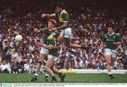 21 July 1991; Ambrose O'Donovan, Kerry in action against John Quane, Limerick, Limerick's Philip Danaher, (extreme right) awaits the breaking ball. Munster Football Final, Kerry v Limerick, Fitzgerald Stadium, Killarney, Co. Kerry. Picture credit; Ray McManus / SPORTSFILE