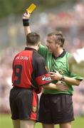 13 July 2003; Referee Aidan Managan issues the yellow card to Down's Sean Ward. Bank of Ireland Ulster Senior Football Final, Tyrone v Down, St. Tighernach's Park, Clones, Co Monaghan. Picture credit; Damien Eagers / SPORTSFILE