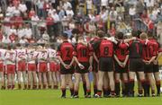 13 July 2003; Tyrone team, left, and the Down team stand together for the national anthem before the start of the game. Bank of Ireland Ulster Senior Football Final, Tyrone v Down, St. Tighernach's Park, Clones, Co Monaghan. Picture credit; David Maher / SPORTSFILE *EDI*