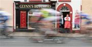 20 May 2013; Butcher John Glynn an his mother Eileen watch competitors in action in Ahascragh, Co. Galway during Stage 2 of the 2013 An Post Rás. Longford - Nenagh. Photo by Sportsfile