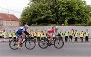 24 May 2013; School children cheer on the Rás at New Inn, Co. Tipperary, as Jacob Rytlewski, USA Astellas Oncology, right, and Olan Barrett, Cork Aquablue, pass by during Stage 6 of the 2013 An Post Rás. Mitchelstown – Carlow. Photo by Sportsfile