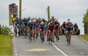24 May 2013; A general view of the peleton passing through Ballraggett, Co. Kilkenny, during Stage 6 of the 2013 An Post Rás. Mitchelstown – Carlow. Photo by Sportsfile