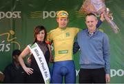 24 May 2013; Marcin Bialoblocki, Britain UK Youth Pro Cycling, is presented with his yellow jersey by Miss An Post Rás Cora Brennan and Patrick Amond, branch manager Carlow, after stage 6 of the 2013 An Post Rás. Mitchelstown – Carlow. Photo by Sportsfile