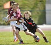 26 May 2013; Cillian Brfennan, Doora / Barefield, Co. Clare, is tackled by Ruairi Dunne, Killeigh, Co. Offaly, right, during the mixed U11 Mini Rugby competition final. Community Games May Festival 2013, Athlone Institute of Technology, Athlone, Co. Westmeath. Picture credit: Pat Murphy / SPORTSFILE
