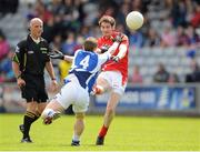 26 May 2013; Brian Donnelly, Louth, scores a point, despite the challenge from Peter O'Leary, Laois. Leinster GAA Football Senior Championship, First Round, Laois v Louth, O'Moore Park, Portlaoise, Co. Laois. Picture credit: Dáire Brennan / SPORTSFILE