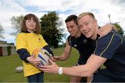 28 May 2013; Member of Bray Lakers Emma Lande, age 6, with Leinster Academy players Noel Reid and Conor Gilsenan, right, in attendance as Leinster Rugby announce community partnership with Bray Lakers. UCD, Belfield, Dublin. Picture credit: Brian Lawless / SPORTSFILE
