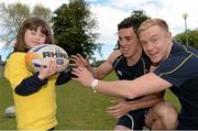 28 May 2013; Member of Bray Lakers Emma Lande, age 6, with Leinster Academy players Noel Reid and Conor Gilsenan, right, in attendance as Leinster Rugby announce community partnership with Bray Lakers. UCD, Belfield, Dublin. Picture credit: Brian Lawless / SPORTSFILE