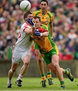 26 May 2013; Donegal captain Michael Murphy clears under pressure from Tyrone substitute Patrick McNiece. Ulster GAA Football Senior Championship, Quarter-Final, Donegal v Tyrone, MacCumhaill Park, Ballybofey, Co. Donegal. Picture credit: Ray McManus / SPORTSFILE