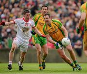 26 May 2013; Donegal captain Michael Murphy clears under pressure from Tyrone substitute Patrick McNiece. Ulster GAA Football Senior Championship, Quarter-Final, Donegal v Tyrone, MacCumhaill Park, Ballybofey, Co. Donegal. Picture credit: Ray McManus / SPORTSFILE