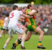 26 May 2013; Neill Gallagher, Donegal, is tackled by Stephen O'Neill and Conor Clarke, Tyrone. Ulster GAA Football Senior Championship, Quarter-Final, Donegal v Tyrone, MacCumhaill Park, Ballybofey, Co. Donegal. Picture credit: Ray McManus / SPORTSFILE