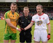 26 May 2013; The Donegal captain Michael Murphy, left, and Tyrone captain Stephen O'Neill shake hands accross referee Joe McQuillan before the game. Ulster GAA Football Senior Championship, Quarter-Final, Donegal v Tyrone, MacCumhaill Park, Ballybofey, Co. Donegal. Picture credit: Ray McManus / SPORTSFILE