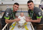 3 June 2013; FAI Junior cup winners Sheriff YC players and brothers Stephen, left, and Lee Murphy with Apollinia Kaleta, 3 months old, from Poland, on a visit to Temple Street Children's Hospital. Temple Street Children's Hospital, Temple Street, Dublin. Picture credit: Ray Lohan / SPORTSFILE