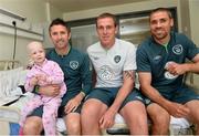 5 June 2013; Republic of Ireland's Robbie Keane, Richard Dunne and Jonathan Walters with Katie McLaughlin, age 3, from Redcastle, Co. Donegal, during a visit to Our Lady's Children's Hospital. Our Lady's Children's Hospital, Crumlin, Dublin. Picture credit: David Maher / SPORTSFILE