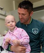 5 June 2013; Republic of Ireland's Robbie Keane with Katie McLaughlin, age 3, from Redcastle, Co. Donegal, during a visit to Our Lady's Children's Hospital. Our Lady's Children's Hospital, Crumlin, Dublin. Picture credit: David Maher / SPORTSFILE