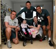 5 June 2013; Republic of Ireland's Richard Dunne, Robbie Keane and Jonathan Walters with Katelyn Reilly, age 18 months and her mother Tracie Reilly, from Ballyconnell, Co. Cavan, during a visit to Our Lady's Children's Hospital. Our Lady's Children's Hospital, Crumlin, Dublin. Picture credit: David Maher / SPORTSFILE