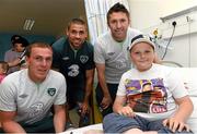 5 June 2013; Republic of Ireland's Richard Dunne, Jonathan Walters and Robbie Keane with Nathan O'Hagan, age 11, from Bray, Co. Wicklow, during a visit to Our Lady's Children's Hospital. Our Lady's Children's Hospital, Crumlin, Dublin. Picture credit: David Maher / SPORTSFILE