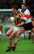 20 February 2000; Crossmaglen's Anthony Cunningham is tackled by UCC's Gary Stack. All-Ireland Club Football semi-final, Crossmaglen v UCC, Parnell Park. Picture credit; Brendan Moran/SPORTSFILE