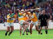 25 July 1999; Offaly's Hubert Rigney reacts with pain after receving a blow from John Carson, Antrim, Offaly v Antrim, All Ireland Hurling Championship Quarter Finals, Croke Park, Dublin. Picture credit; Ray McManus/SPORTSFILE