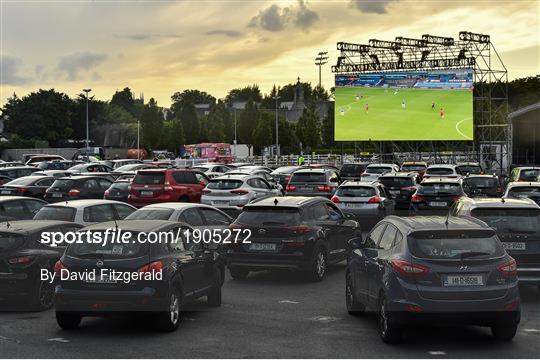 Irish supporters watch the Merseyside derby from a Drive In Theatre in Dublin