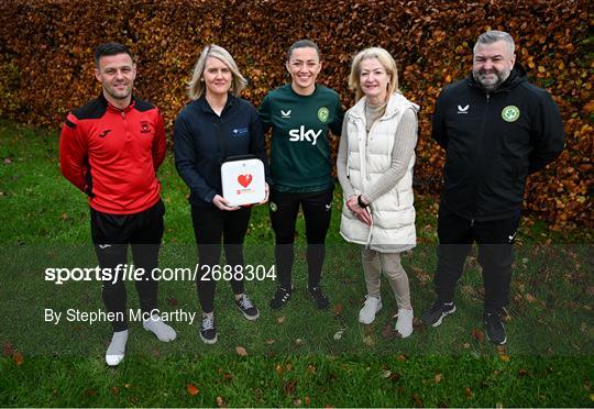 Republic of Ireland's Katie McCabe Presents a Defibrillator to Kilnamanagh AFC